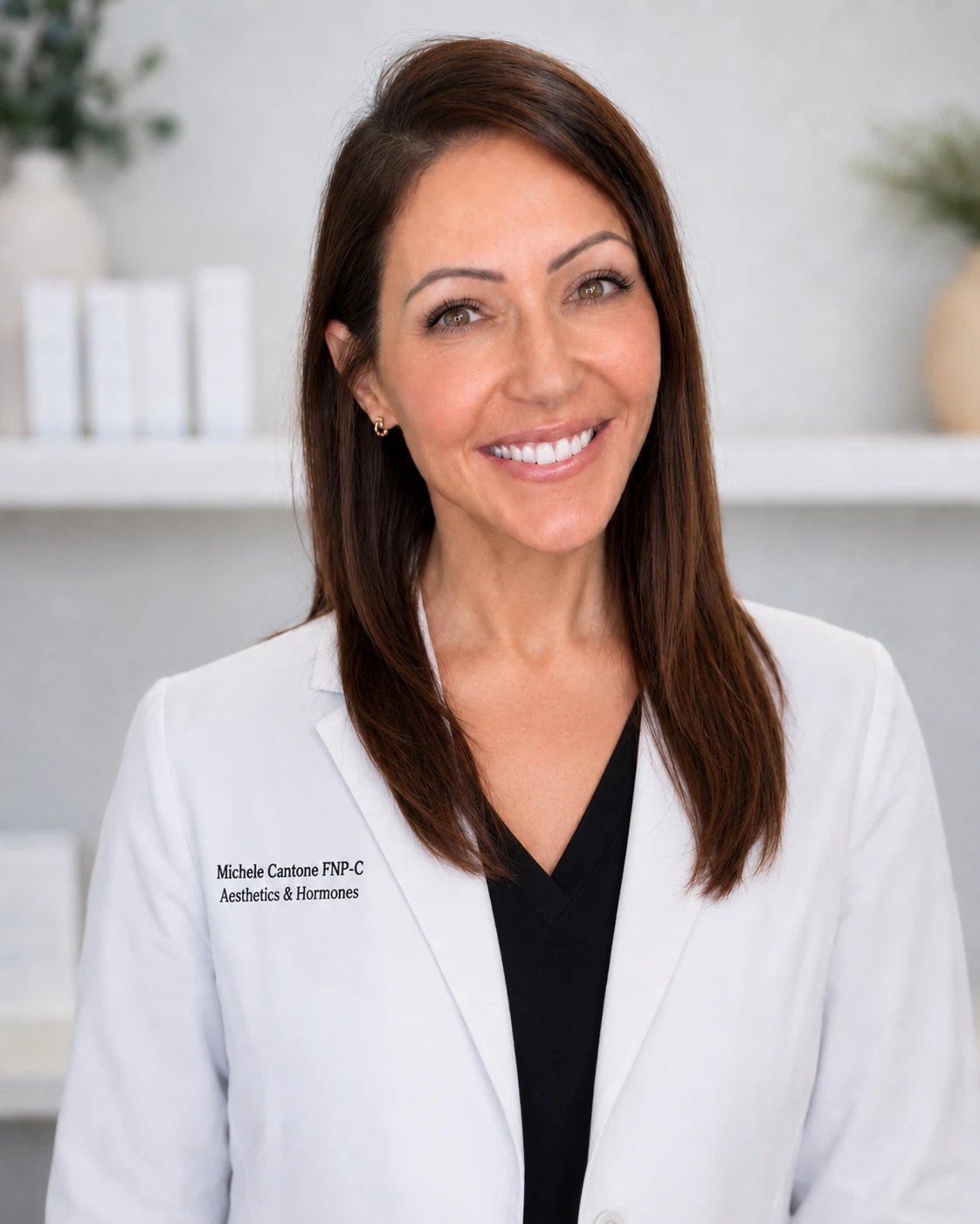 Michele Cantone, founder and nurse practitioner, smiling in her white clinician coat