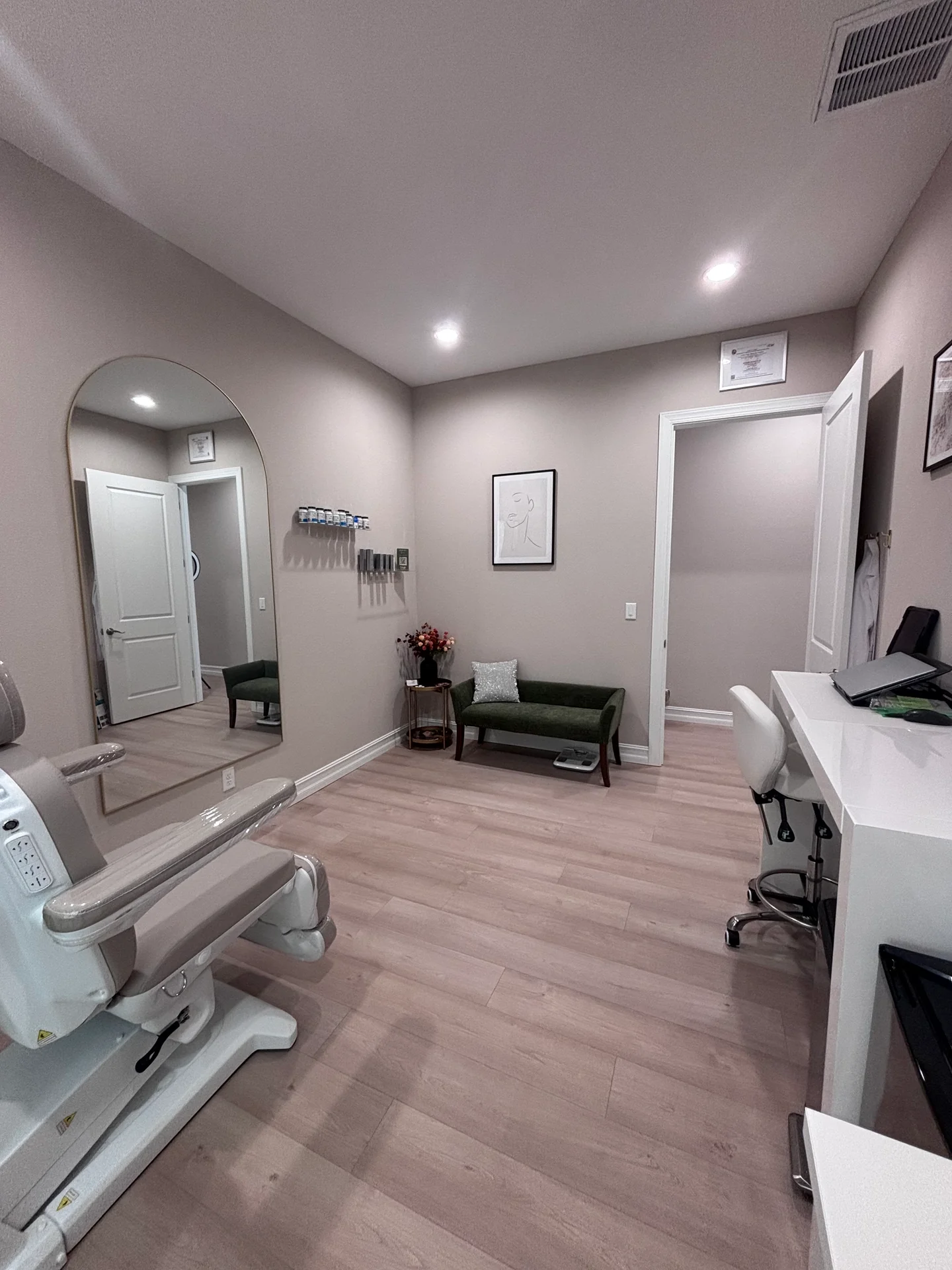 A green bench, arched mirror and desk in Southern’s Trinity consultation space